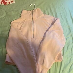 A lululemon scuba hoodie is lightly worn and size small/xs. It is a peachy pink.